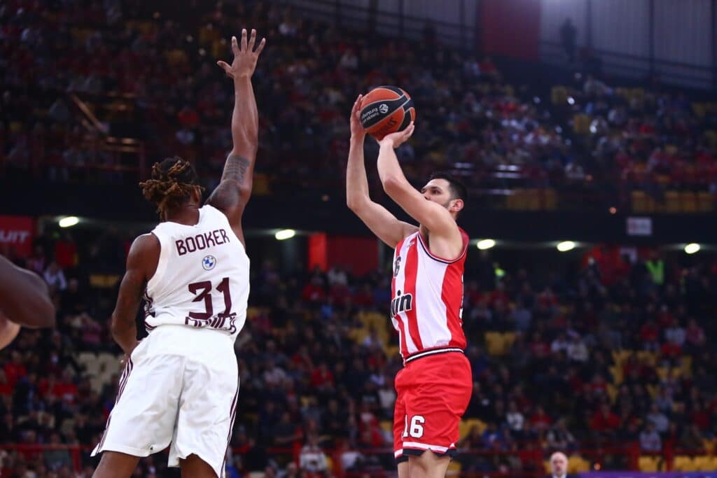 Photo by Olympiacos B.C. on December 08 2023. May be an image of 3 people people playing basketball backboard ball and text