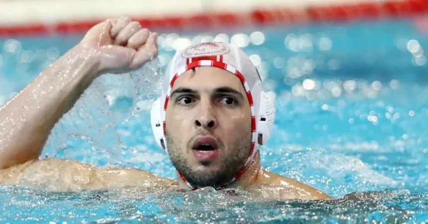 Ο Γιάννης Φουντούλης με το σκουφάκι του Ολυμπιακού πανηγυρίζει μέσα στο νερό