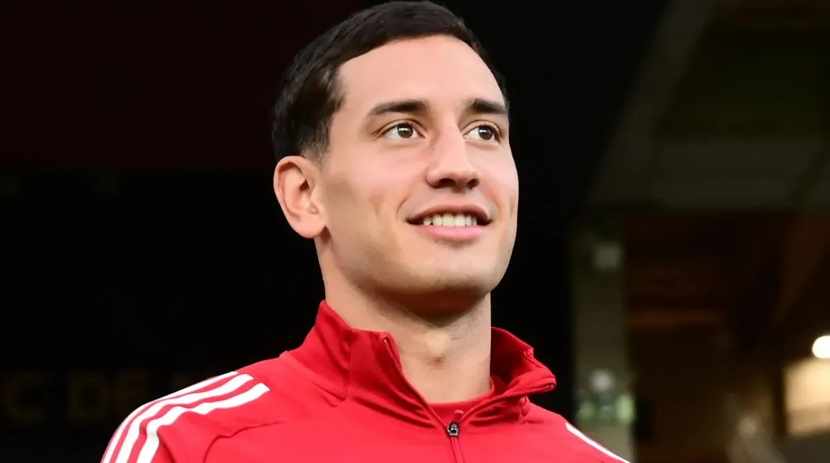 μέσος του Ολυμπιακού Σαντιάγκο Έσε με την κόκκινη προπονητική ζακέτα της ομάδας.