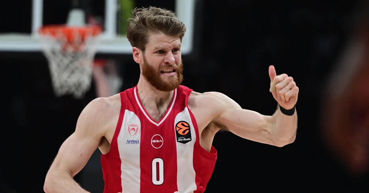 Ο Τόμας Γουόκαπ του Ολυμπιακού παίζει πιεστική άμυνα σε αντίπαλο γκαρντ κατά τη διάρκεια ευρωπαϊκού αγώνα.